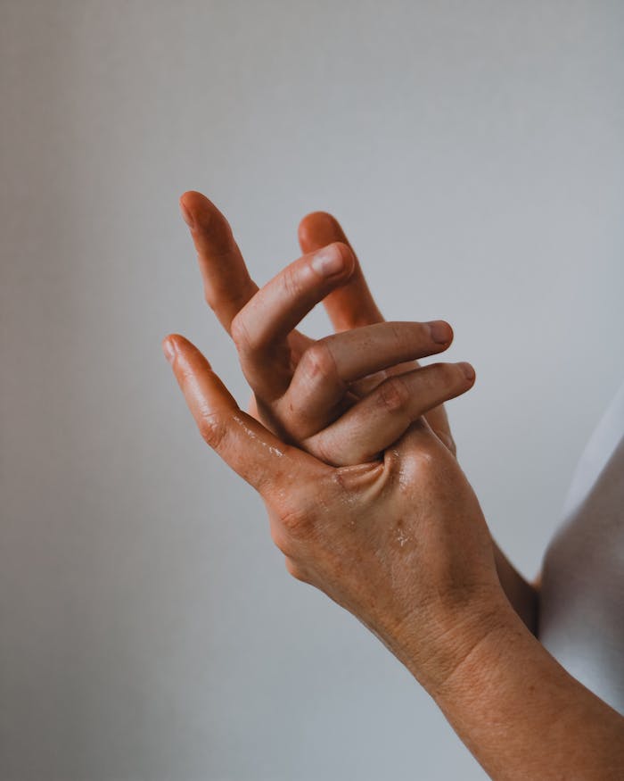 Close-up of hands showing a gentle touch gesture with soft natural light, ideal for wellness themes.